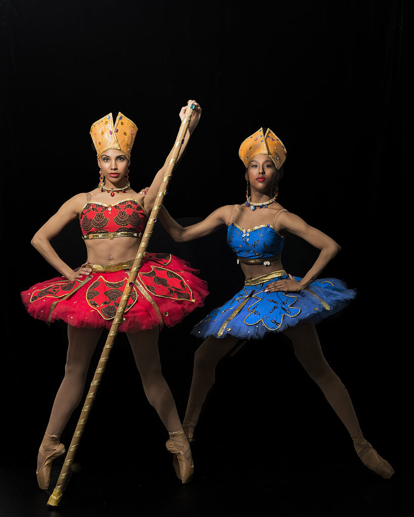 2 Hiplet ballerinas on point.  One in red and the other in blue