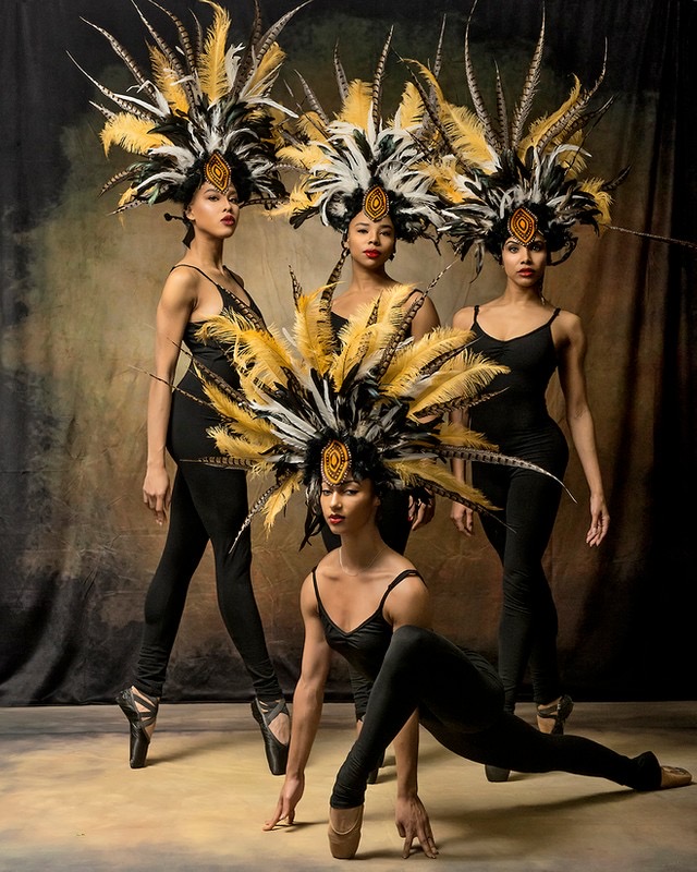 4 Hiplet Ballerinas in black leotards, tights and brown, white and black feather headresses
