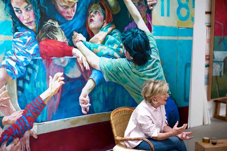 Xenia Hausner talking in front of her painting representing a group of people
