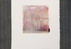 A piece of paper, on pinstripe cloth, with abstract faded yellow and red lines on it.