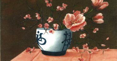 Painting of pink flowers in a blue and white bowl with Chinese-like characters drawn on the bowl, on a tablecloth.