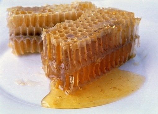 honeycomb on a plate , oozing with honey
