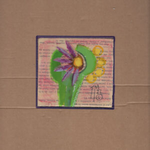 A green, purple and yellow flower on printed paper on board