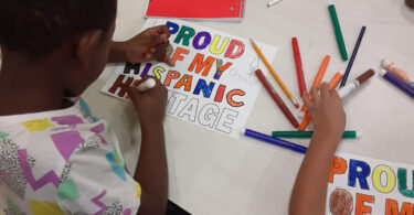 Child creating artwork at the Woodycrest after school Program